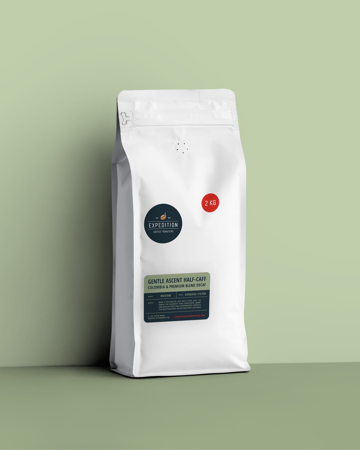Half-caff coffee beans in a white coffee bag from expedition coffee roasters with a label on a green background, 2.1kg of beans