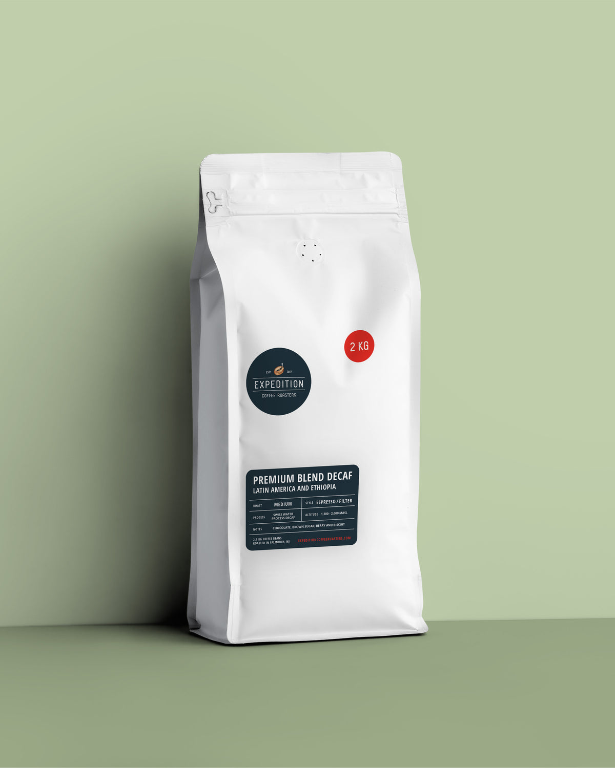 Decaffinated coffee in a white bag with a label on a green background of Expedition coffee in nova scotia canada