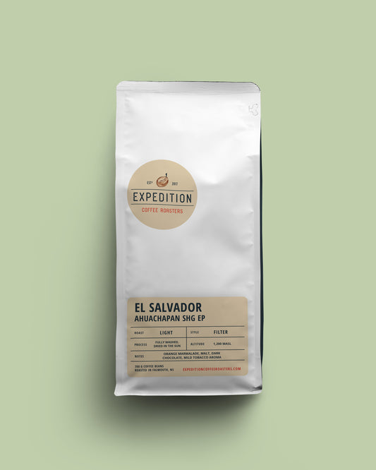 El Salvador Ahuachapan beans in coffee bag labeled 'Expedition Coffee Roasters' on a light green background